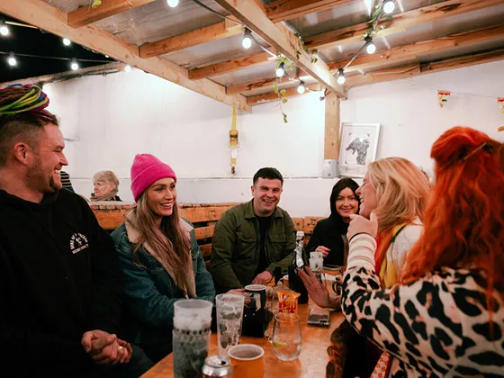 Friends share drinks and conversation at the festival