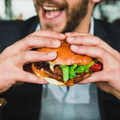 A visitor enjoys a loaded burger from one of the festival's street food traders